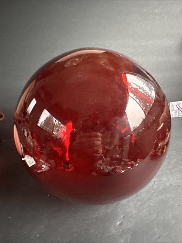 Large red glass ball that - , can